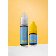Two Brovi e-liquid bottles on a white surface against a yellow background. The larger bottle has a clear cap and a blue label, while the smaller bottle has a yellow cap and a matching blue label.