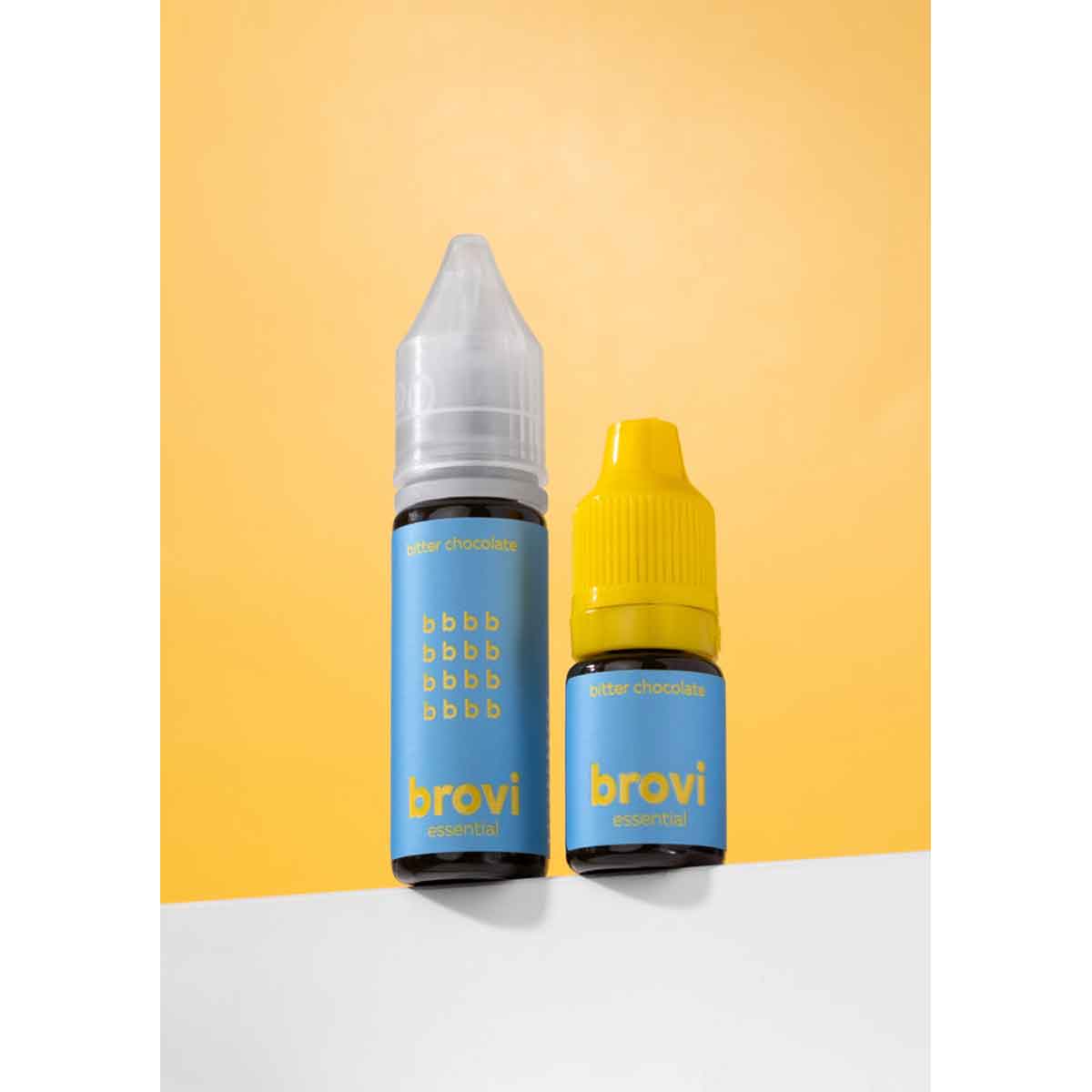 Two Brovi e-liquid bottles on a white surface against a yellow background. The larger bottle has a clear cap and a blue label, while the smaller bottle has a yellow cap and a matching blue label.