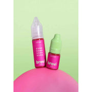 Two Brovi e-liquid bottles in the 'purrify liquid' flavor, one with a clear cap and one with a light green cap, both featuring bright pink labels, displayed on a pink sphere against a light green background.