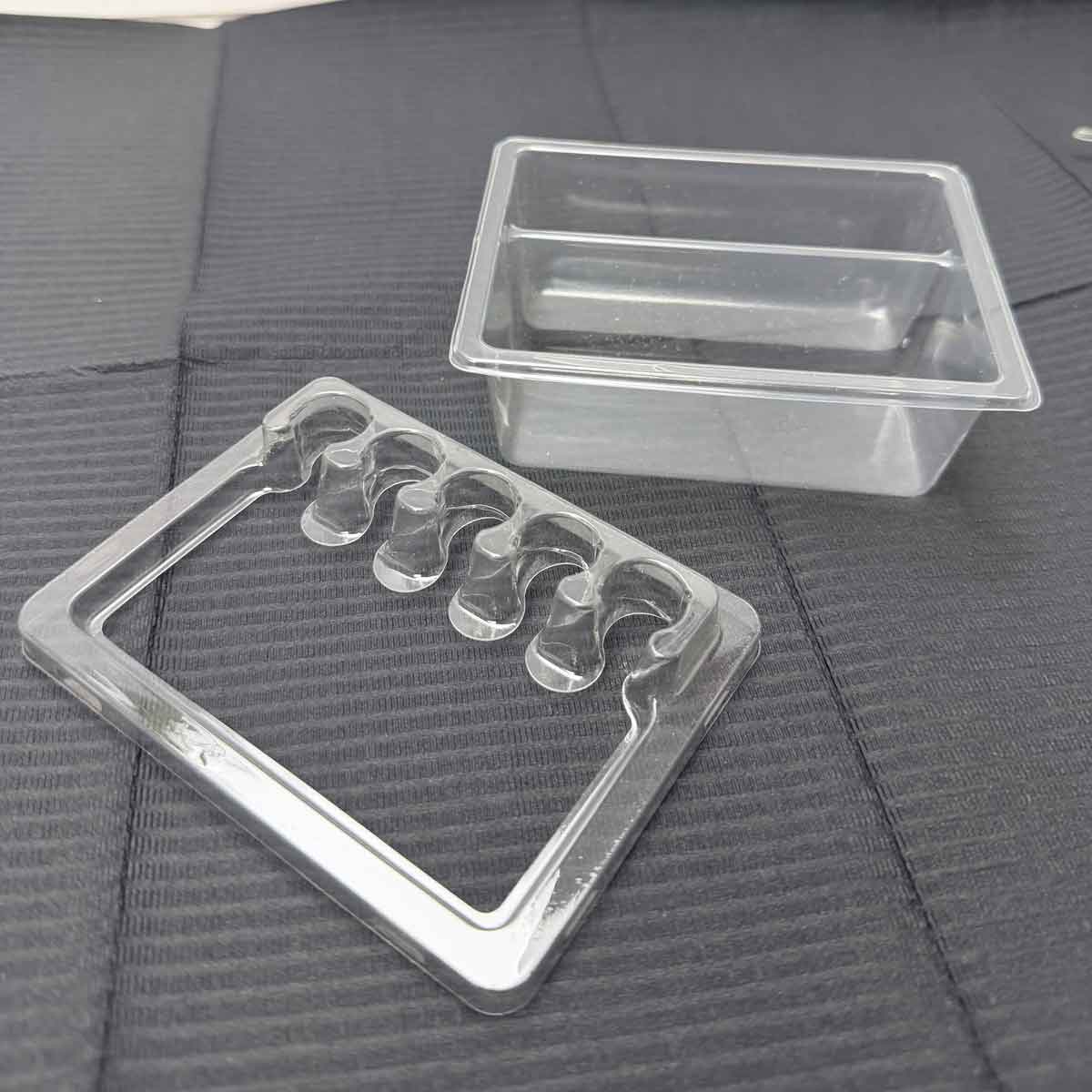 Tattoo tray mold with wavy design on a textured black surface