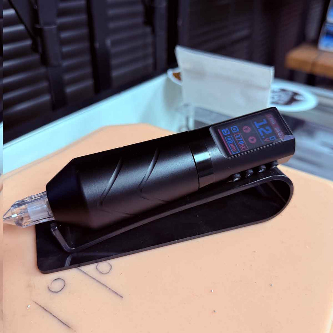 Black tattoo machine on a table with a blurred background