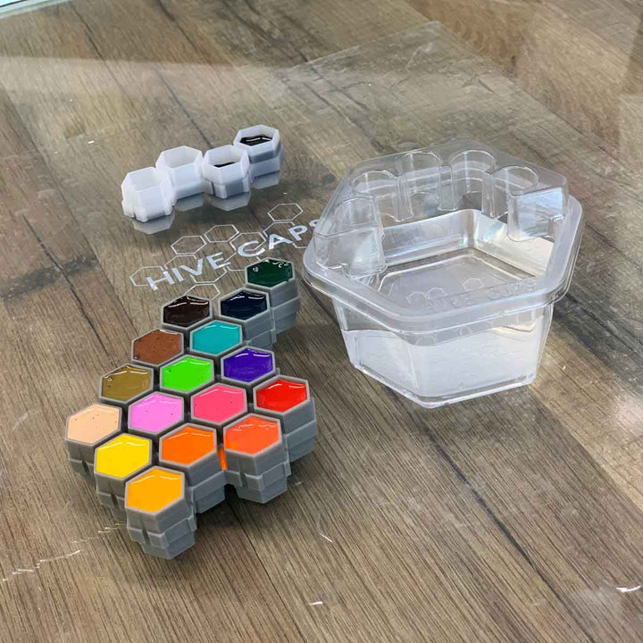 Hive Cups container with a clear plastic lid on a wooden surface.