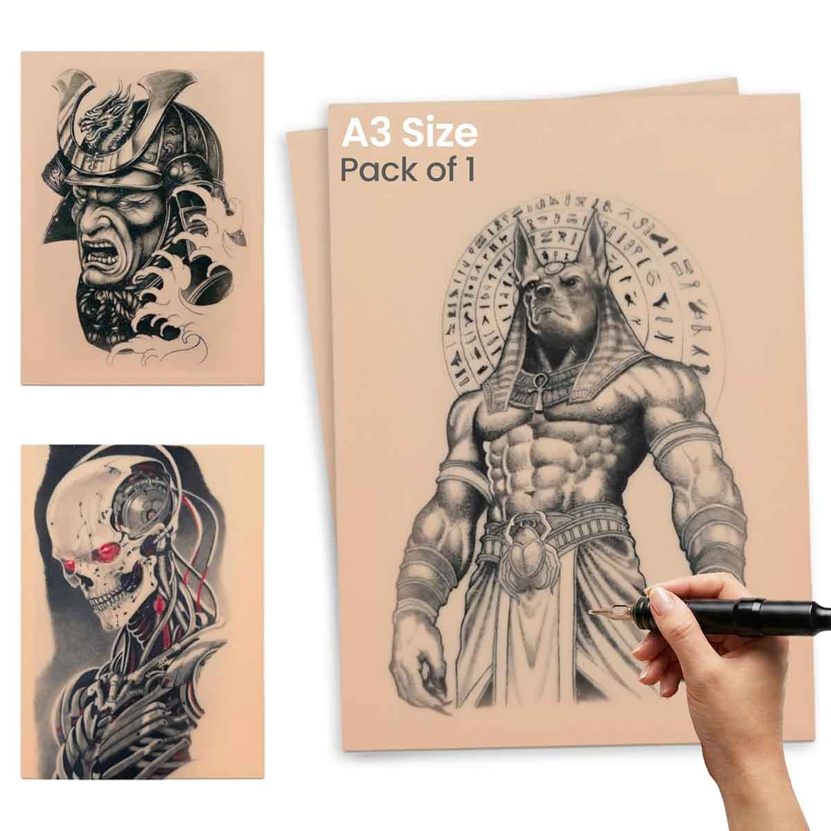 A3 size tattoo design book with Egyptian warrior illustration and other tattoos, held by a hand with a pen.